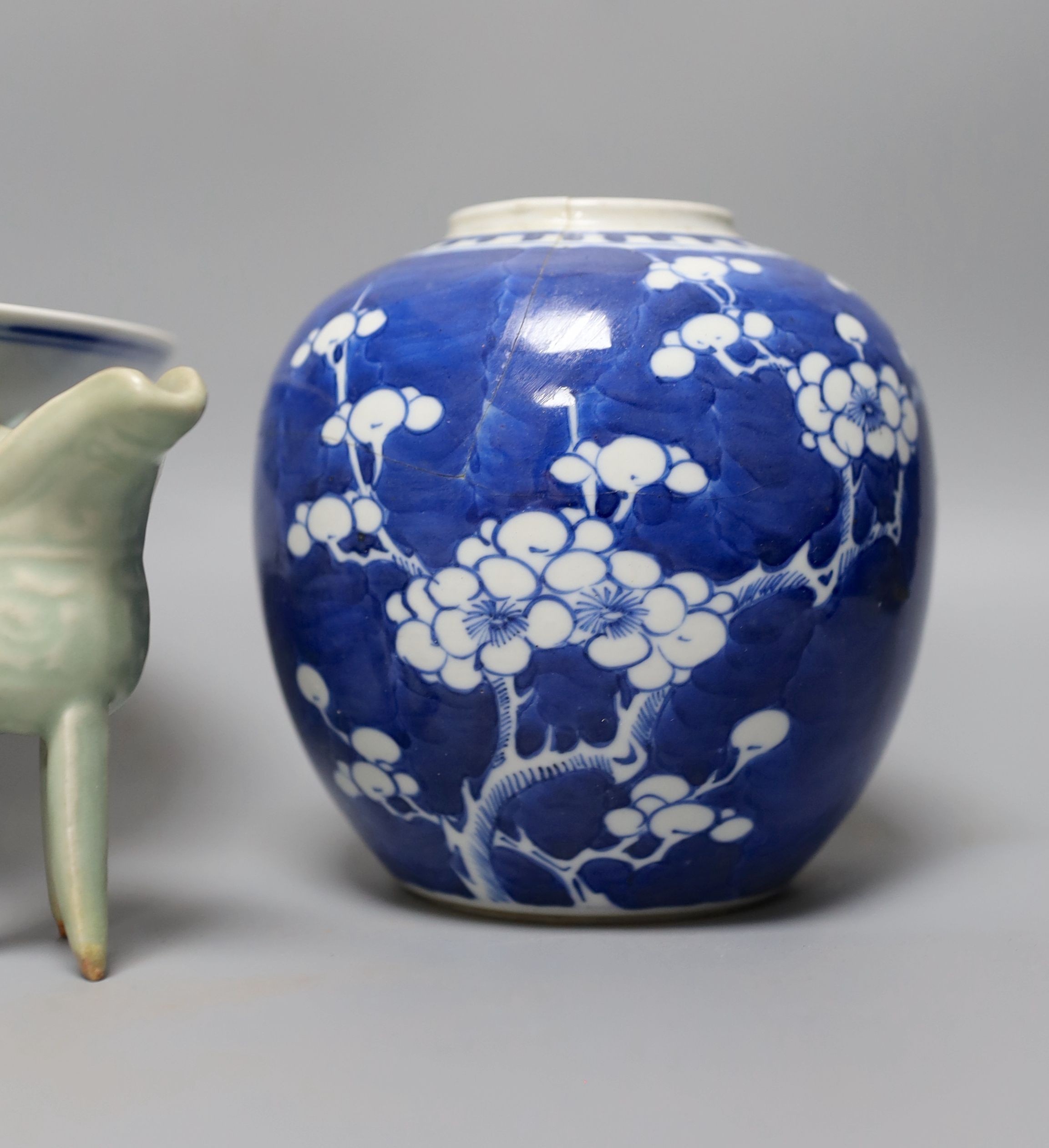 A Chinese blue and white “dragon“ footed dish, 25 cm diameter a Chinese blue and white prunus jar and a celadon glazed small vessel (3)